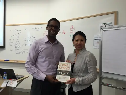 Reader holding Actionable Intelligence in Singapore, August 2015
