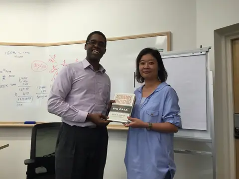 Reader holding Actionable Intelligence in Singapore, August 2015