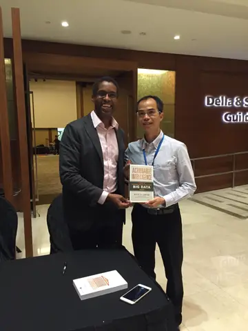 Reader holding Actionable Intelligence in Singapore, November 2015