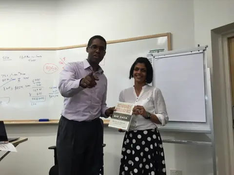 Reader holding Actionable Intelligence in Singapore, August 2015
