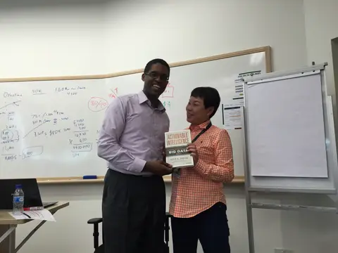 Reader holding Actionable Intelligence in Singapore, August 2015