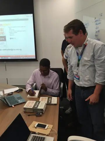Reader holding Actionable Intelligence in Singapore, October 2015