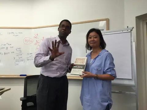 Reader holding Actionable Intelligence in Singapore, August 2015