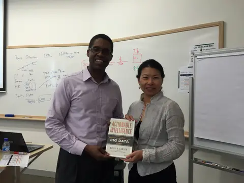 Reader holding Actionable Intelligence in Singapore, August 2015
