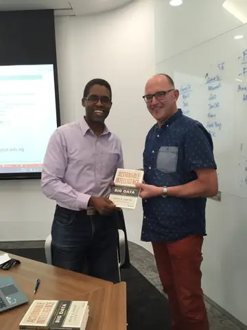 Reader holding Actionable Intelligence in Singapore, October 2015