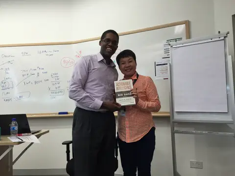 Reader holding Actionable Intelligence in Singapore, August 2015