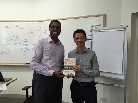Reader holding Actionable Intelligence in Singapore, August 2015