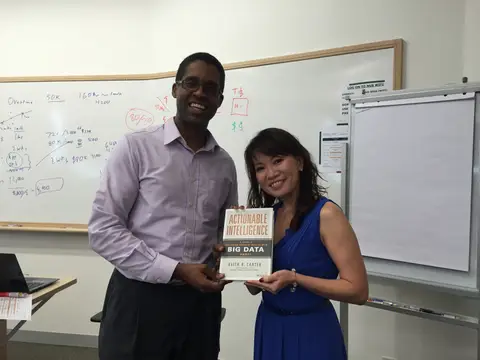 Reader holding Actionable Intelligence in Singapore, August 2015