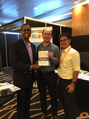 Reader holding Actionable Intelligence in Singapore, June 2015