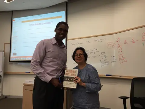 Reader holding Actionable Intelligence in Singapore, August 2015
