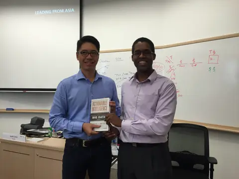 Reader holding Actionable Intelligence in Singapore, August 2015