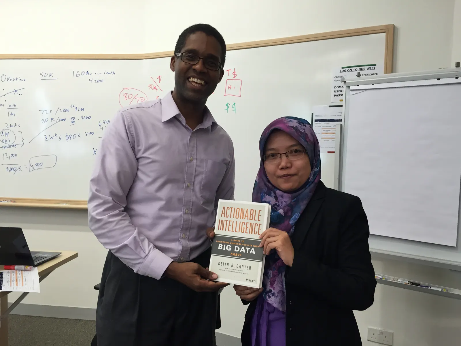 Reader holding Actionable Intelligence in Singapore, August 2015