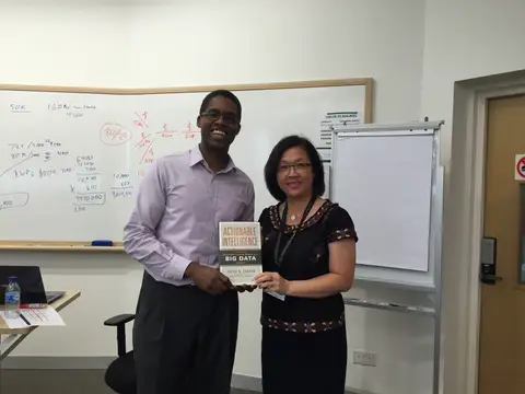 Reader holding Actionable Intelligence in Singapore, August 2015
