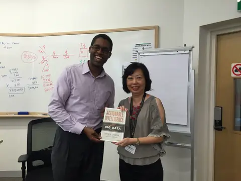 Reader holding Actionable Intelligence in Singapore, August 2015