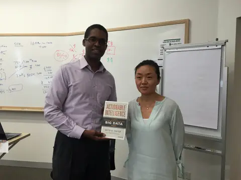 Reader holding Actionable Intelligence in Singapore, August 2015