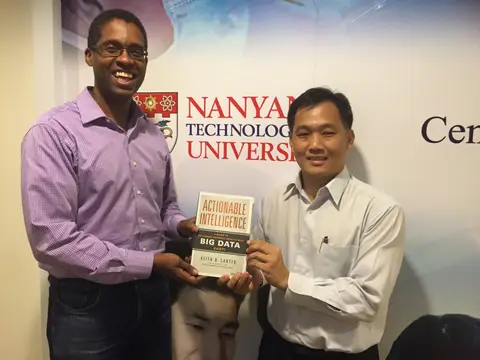 Reader holding Actionable Intelligence in Singapore, August 2015