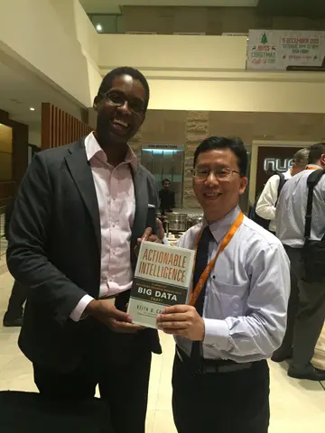 Reader holding Actionable Intelligence in Singapore, November 2015