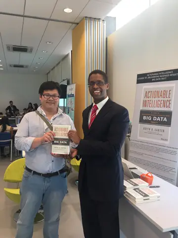 Reader holding Actionable Intelligence in Singapore, April 2016